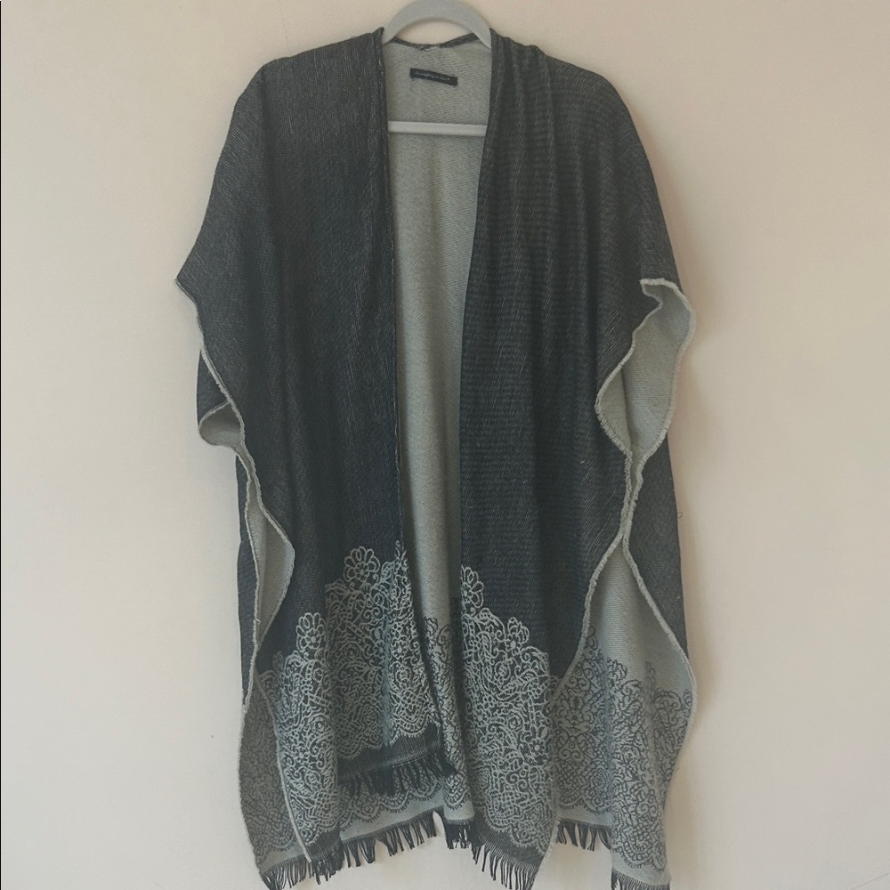 Long shawl with open front and armholes.